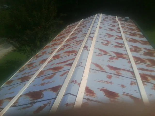 Rusted metal roof panels with new wood purlins before replacement — Storm Damage Roof Repair in Mcconnelsville by Roofing Brothers