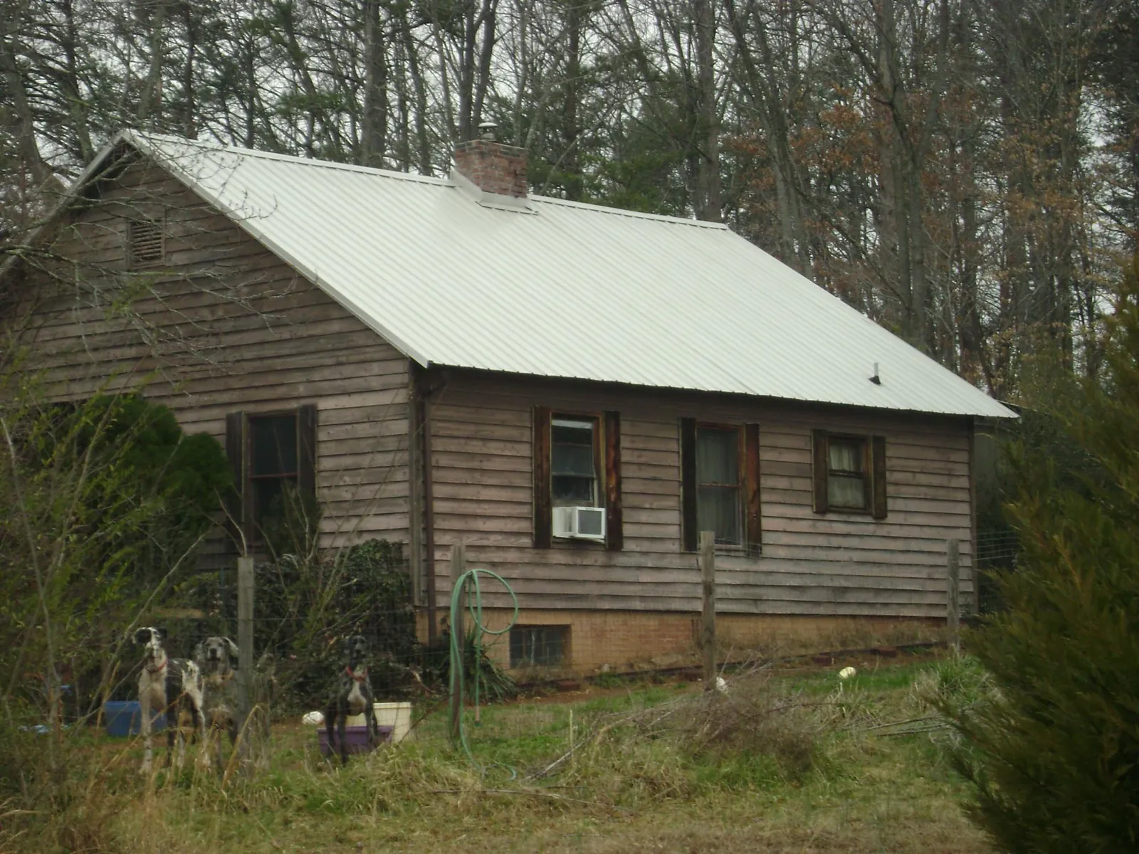 White metal roof on an old wood sided farmhouse, from a Metal Roof Installation job in Mcconnelsville